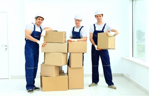 Professional office removal staff transporting furniture and IT equipment