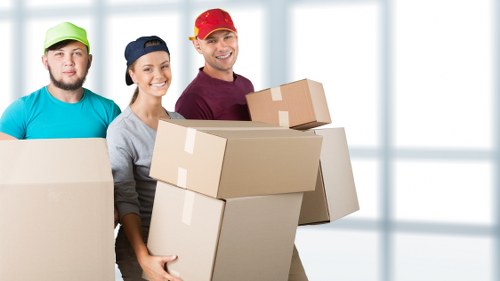 IT equipment and workstations being carefully moved for an office relocation