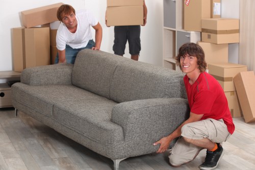 Professional Croftonpark movers loading furniture into a removal van