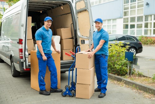Removal workers loading furniture for a Croftonpark relocation